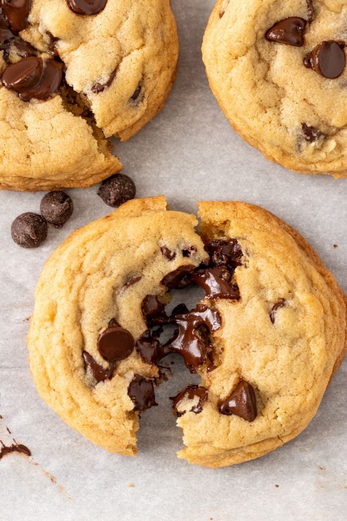 thick chocolate chip cookie is broken to show chocolate puddles inside